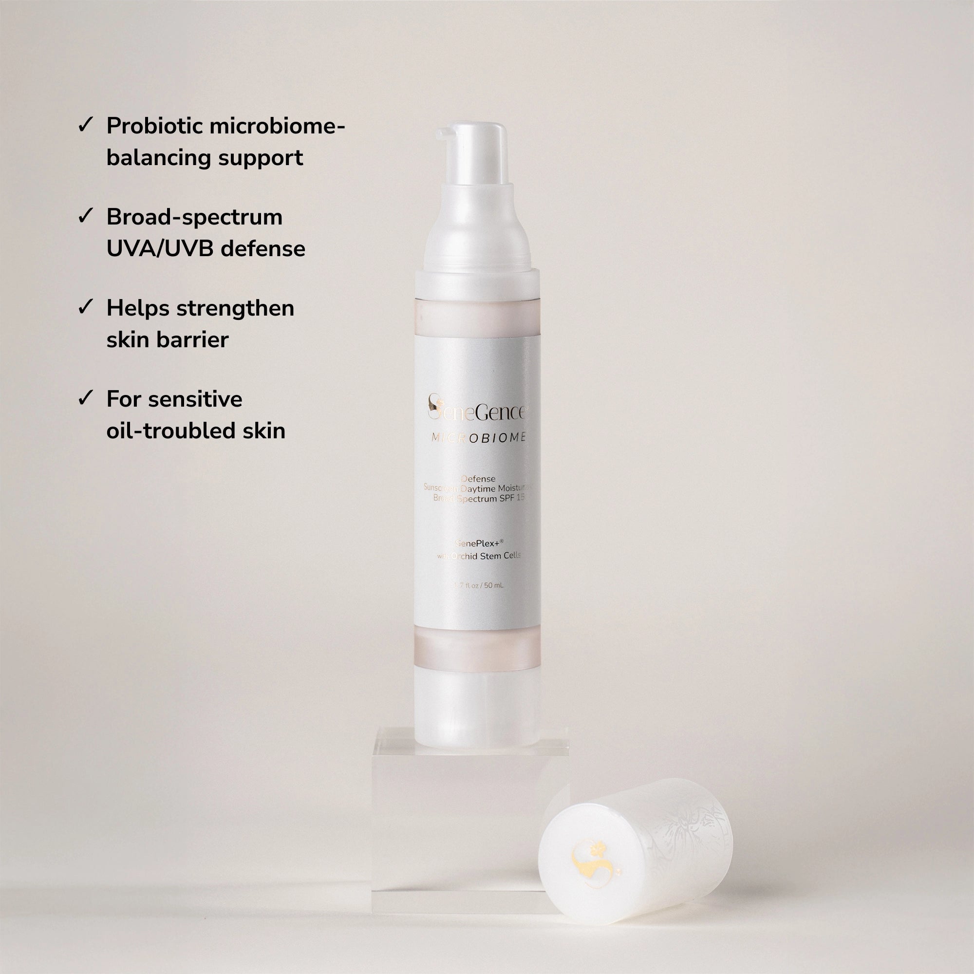 Official SeneGence product image for Microbiome Defense Daytime Moisturizer Broad Spectrum SPF 15. The package label reads “SeneGence Microbiome,” “Defense Sunscreen Daytime Moisturizer Broad Spectrum SPF 15,” “SenePlex+® with Orchid Stem Cells,” and “1.7 fl oz / 50 mL.” Visible claim bullets read: “Probiotic microbiome-balancing support”; “Broad-spectrum UVA/UVB defense”; “Helps strengthen skin barrier”; and “For sensitive oil-troubled skin.”