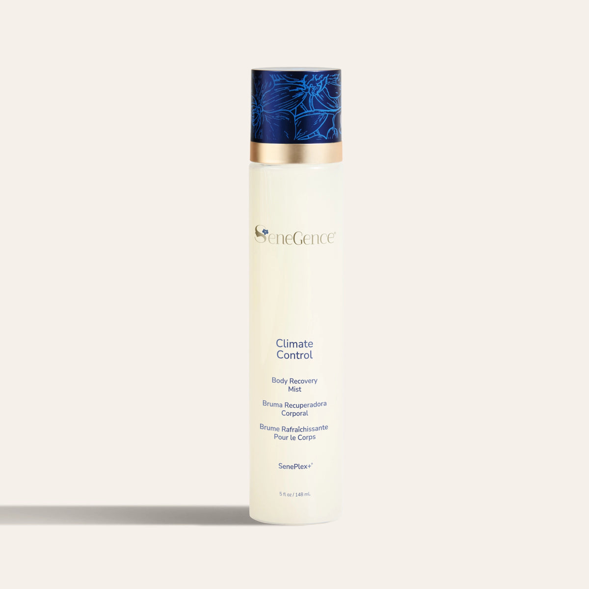 A cream bottle with a dark blue orchid-decorated cap, Climate Control Body Recovery Mist.