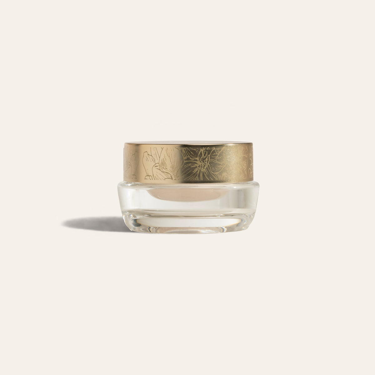 EyeCrème by SeneGence: a clear jar of pale cream with an orchid-engraved gold lid.