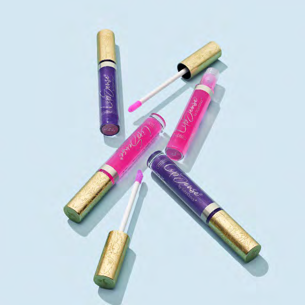 Pink and purple LipSense® pH Glossy Tint tubes with gold caps and open applicators on a pale blue background.