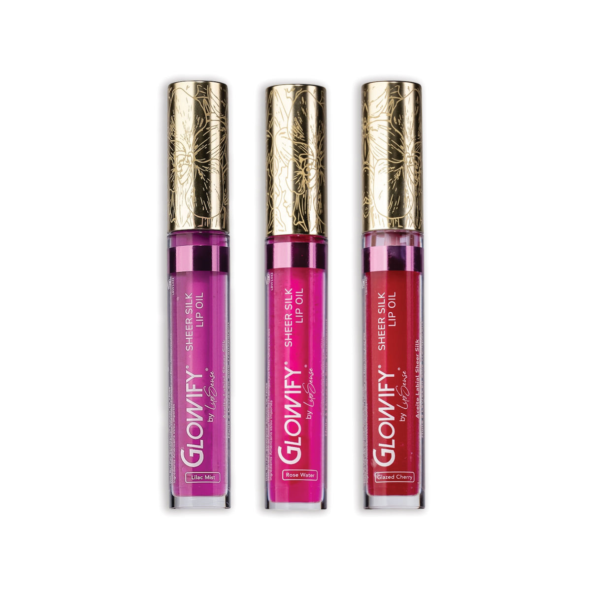 Three clear lip-oil tubes in violet lilac, hot pink and cherry red, each with an orchid-engraved gold cap, Glowify Sheer Silk Lip Oil Collection.