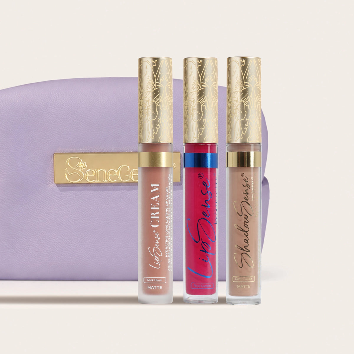 Three gold-capped tubes in neutral pink, rosy red and taupe beside a lavender pouch, Limited-Edition Blushed Rose Collection.