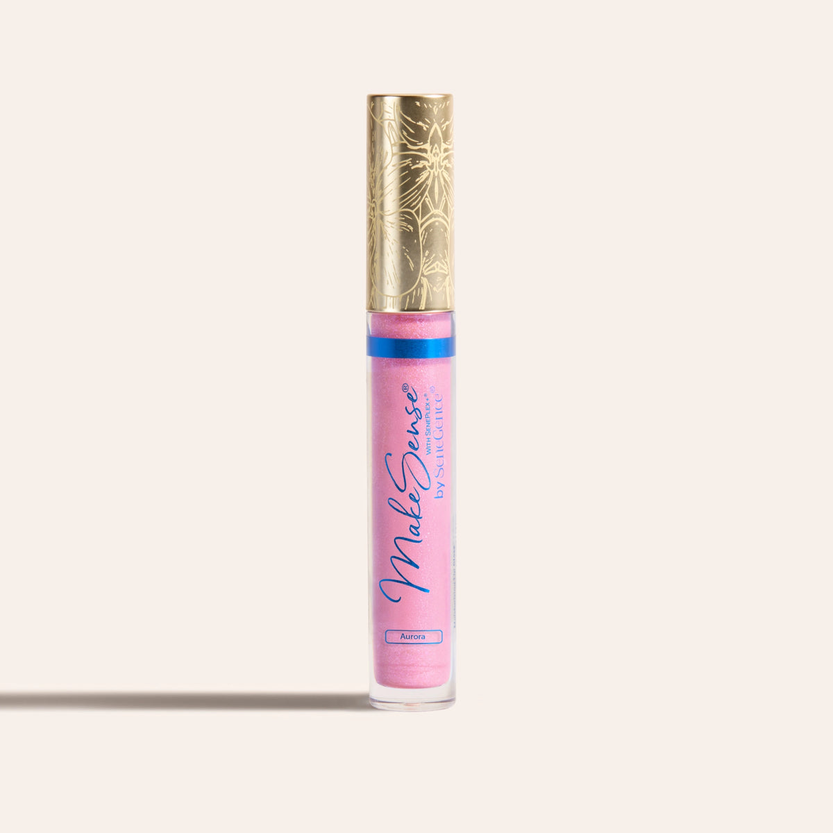 A pink highlighter tube with a gold cap, MakeSense Pearlizer Highlighter Wand.