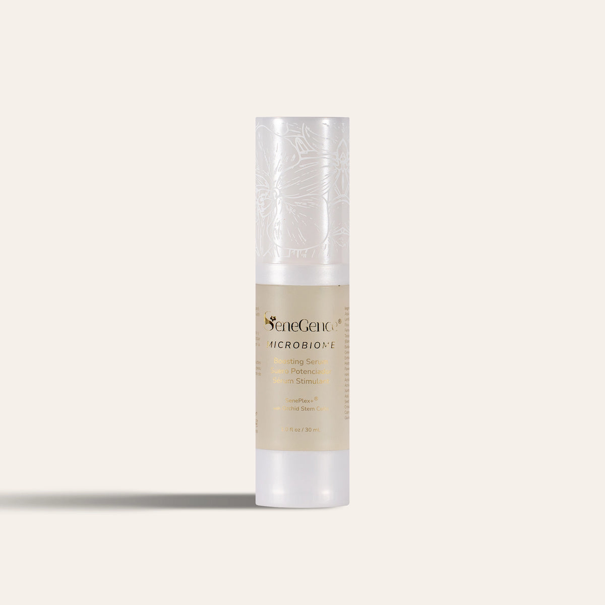 A slim airless serum bottle with a frosted pearl-white cap printed with white orchid line art, a beige label with gold-tone text and a frosted white base, Microbiome Boosting Serum.