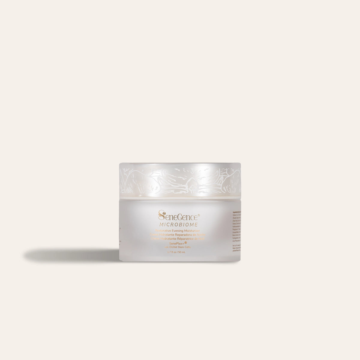 A squat frosted-white jar with a pearl-white lid printed with white orchid line art and gold-tone label text, Microbiome Restorative Evening Moisturizer.