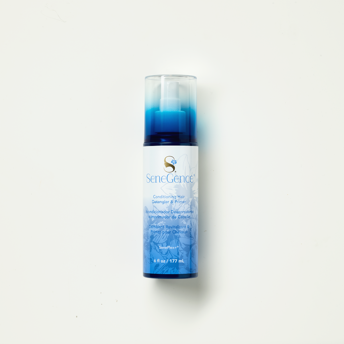 A blue-and-white hair-care spray bottle with a clear cap, SeneGence Conditioning Hair Detangler and Primer.