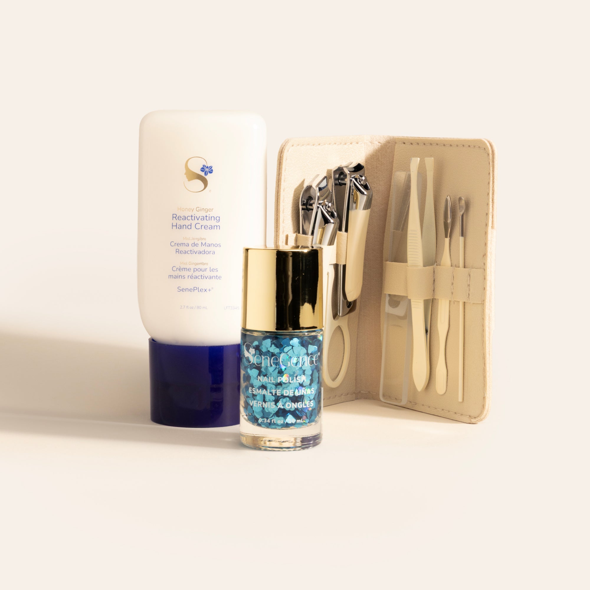 Wrapped with Love Nail Care Set by SeneGence: Honey Ginger Reactivating Hand Cream, a gold-capped bottle of blue-heart nail topper and an open cream-colored manicure case.